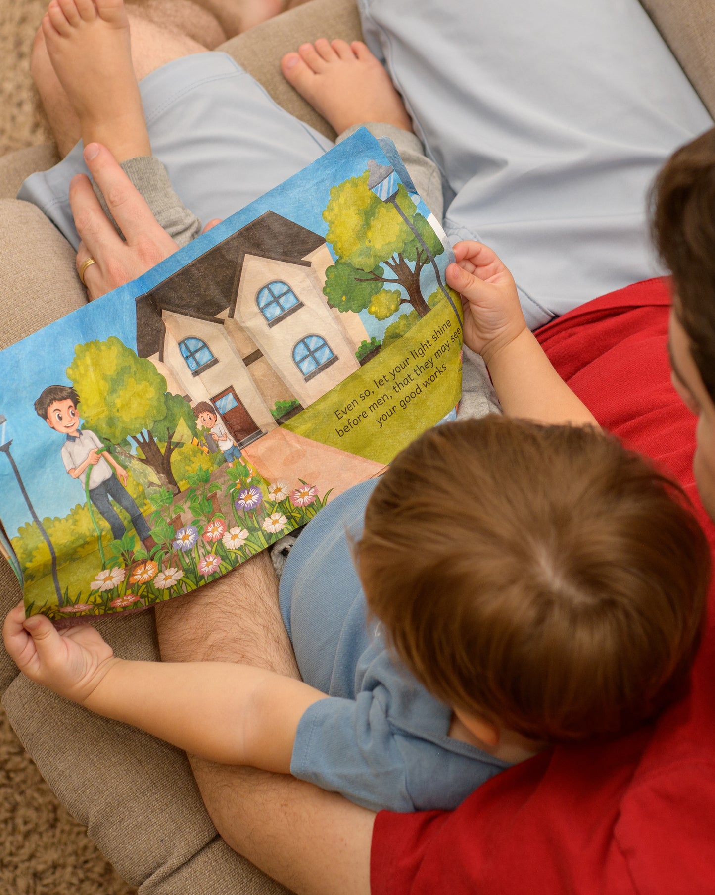 Father and son reading You are the Light of the World